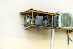 Air conditioner without casing with dust-covered parts